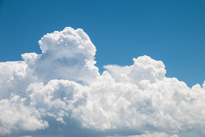 Blue sky with a thick white fluffy cloud
