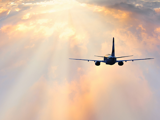 Passenger plane flying through clouds Passenger plane flying through clouds, Serjio74/iStock/Thinkstock