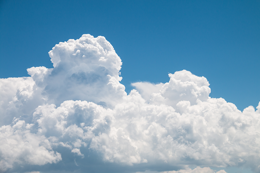 Blue sky with a thick white fluffy cloud