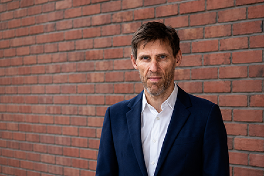 Jørn Kristiansen stood in front of a wall