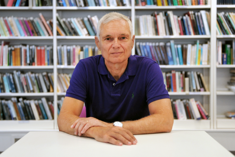 Massimo Bonavita sat at a table in front of books