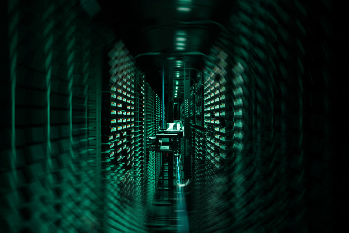 Photo of ECMWF's HPC illuminated green. The image is slightly swirled 