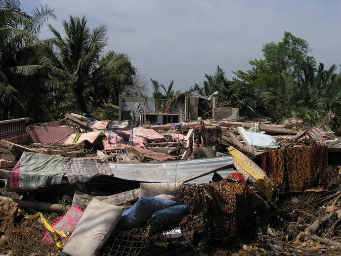 A building in Indonesia flattened by a landspout. There is no building structure and lots of rubble and blankets