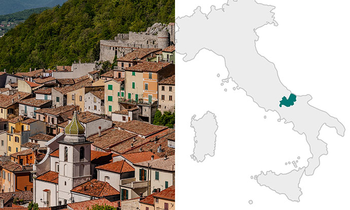 View of a hillside town in Italy alongside a map highlighting the Molise region in central-southern Italy.